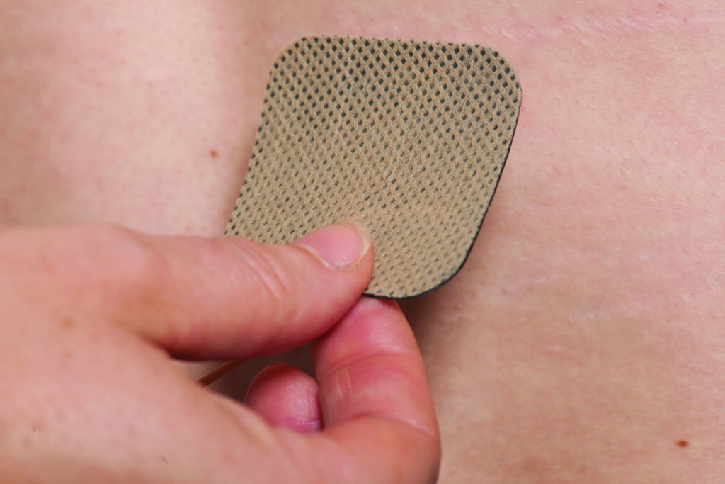 Picture 5 - photograph of a pad being placed on a persons back