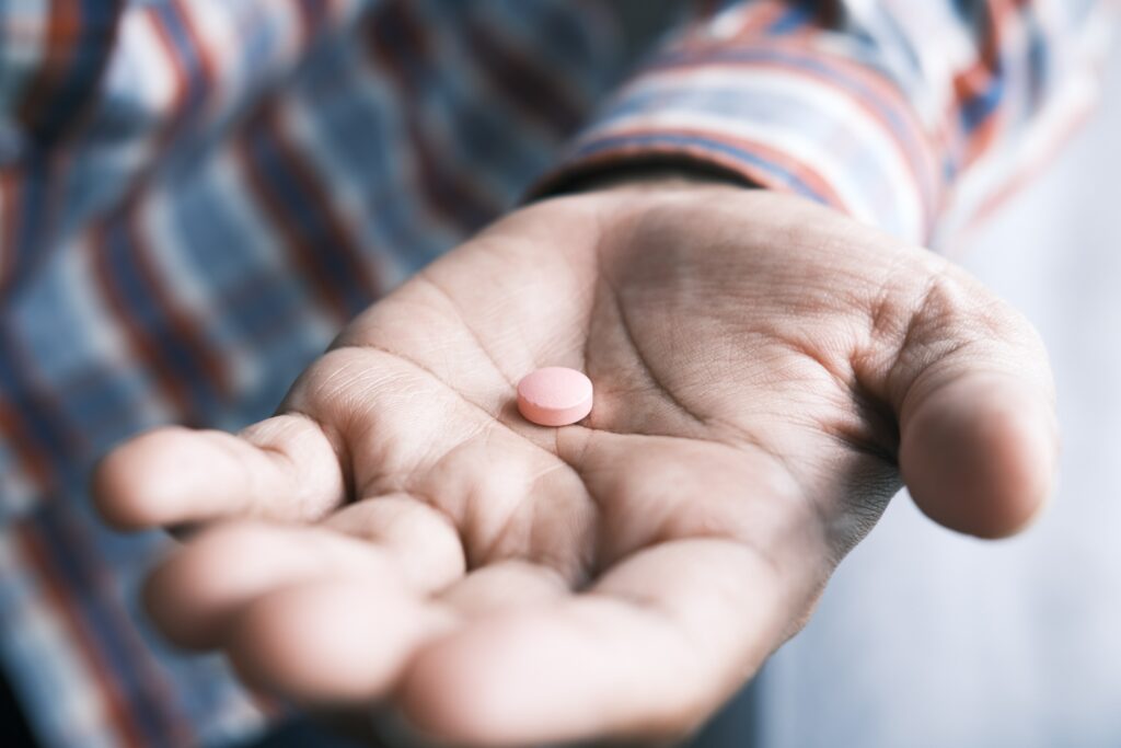 Hand holding medication.
