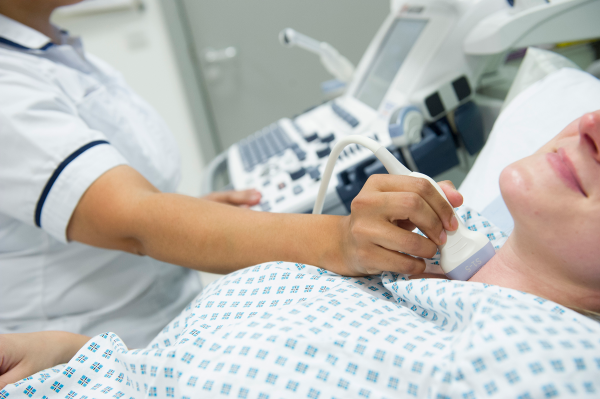 Lady receiving ultrasound on her neck