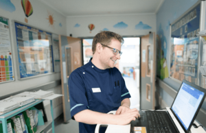 member of staff using a laptop