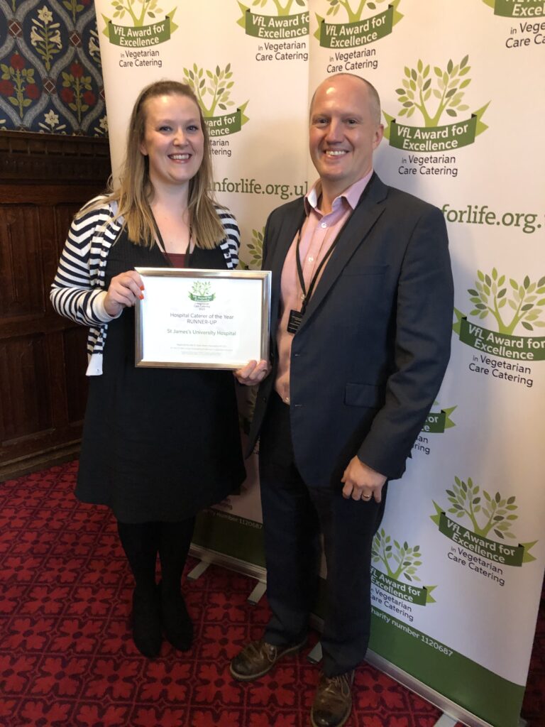 Two members of staff pictured with their certificate at the awards ceremony