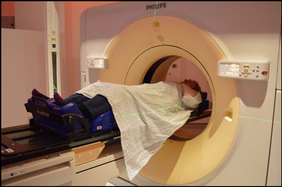 Patient lying on CT scanner couch.