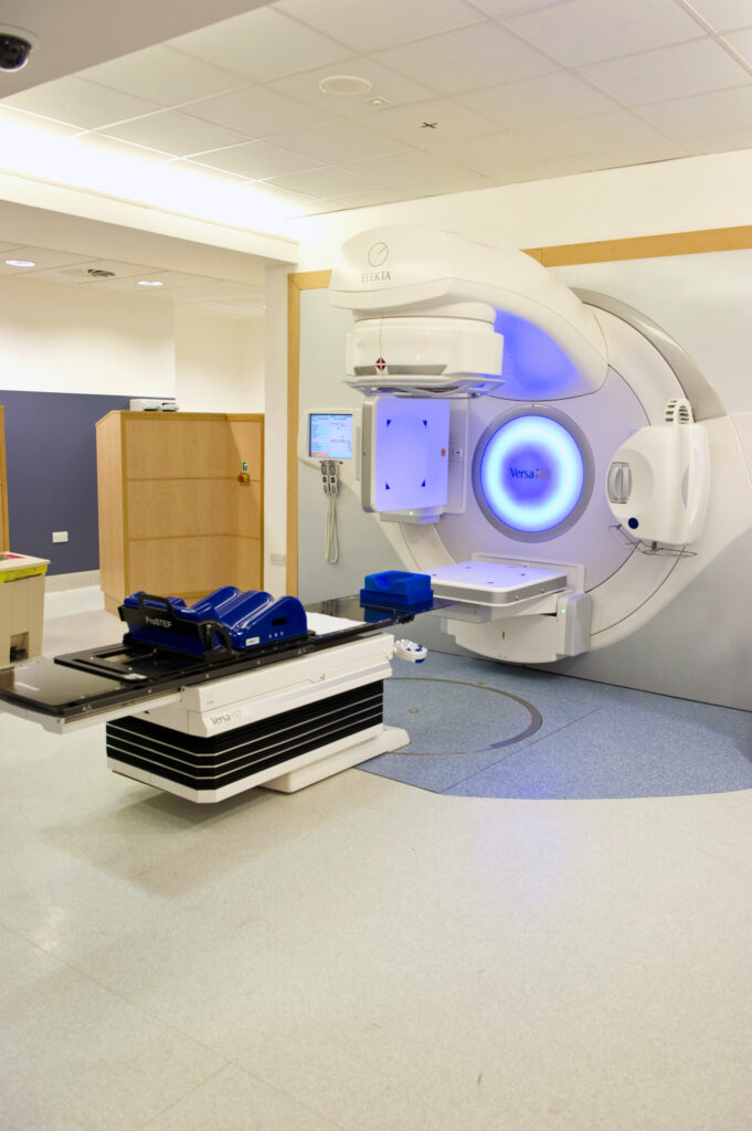 Photograph of linear accelerator in treatment room.