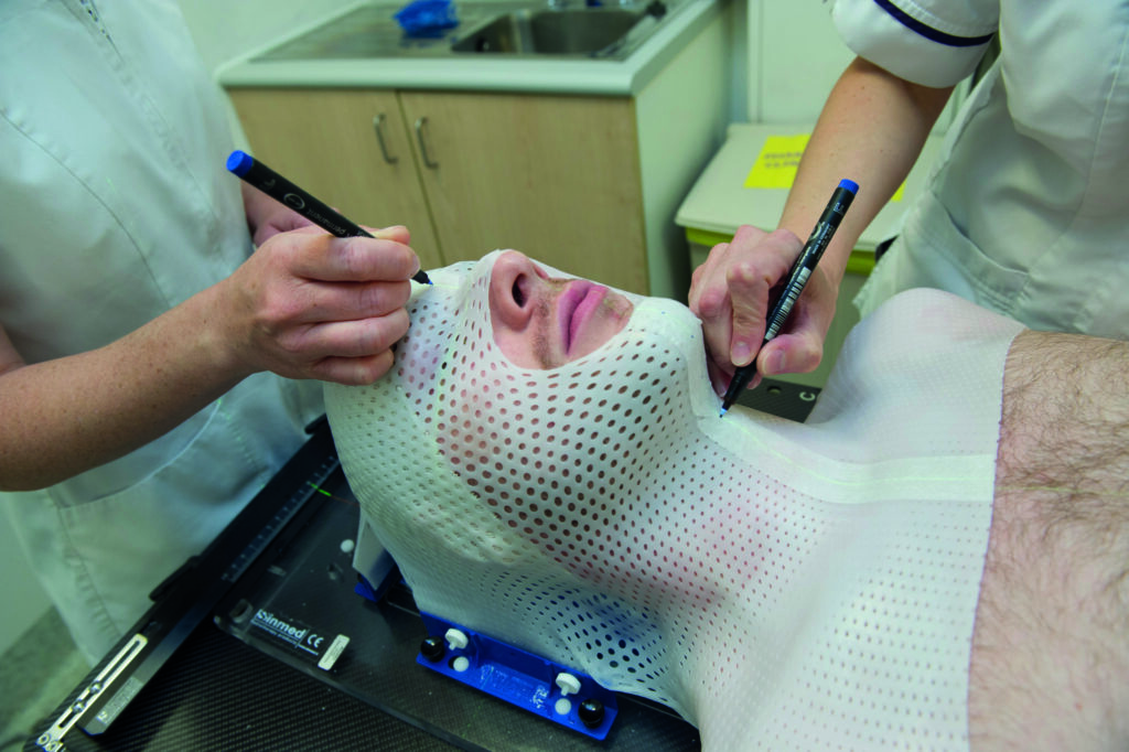 Photograph of a person with a mask made with a sheet of thermoplastic mesh.