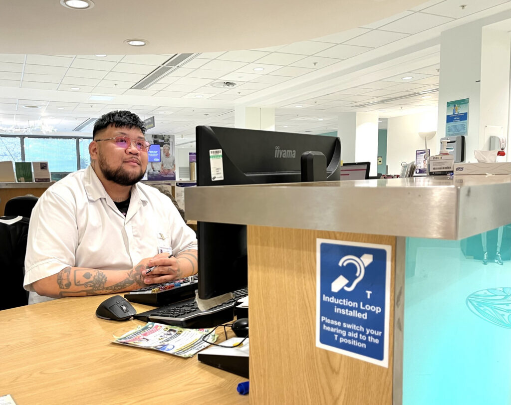 Photograph of patient at Main Reception.