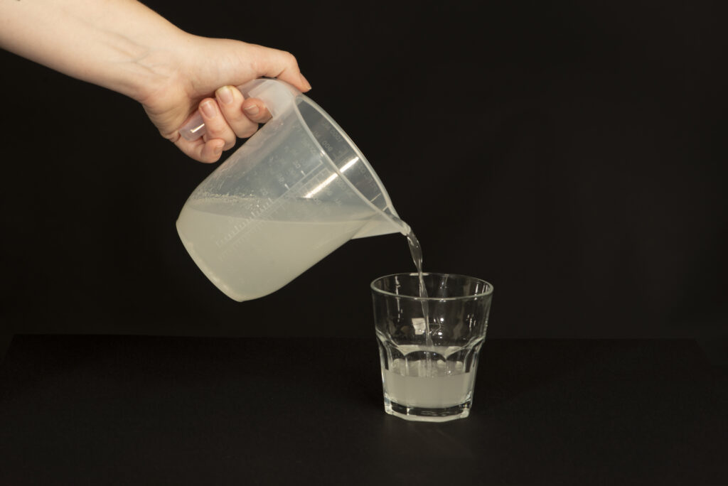 Photograph of the MOVIPREP® drink being poured from a jug into a glass.