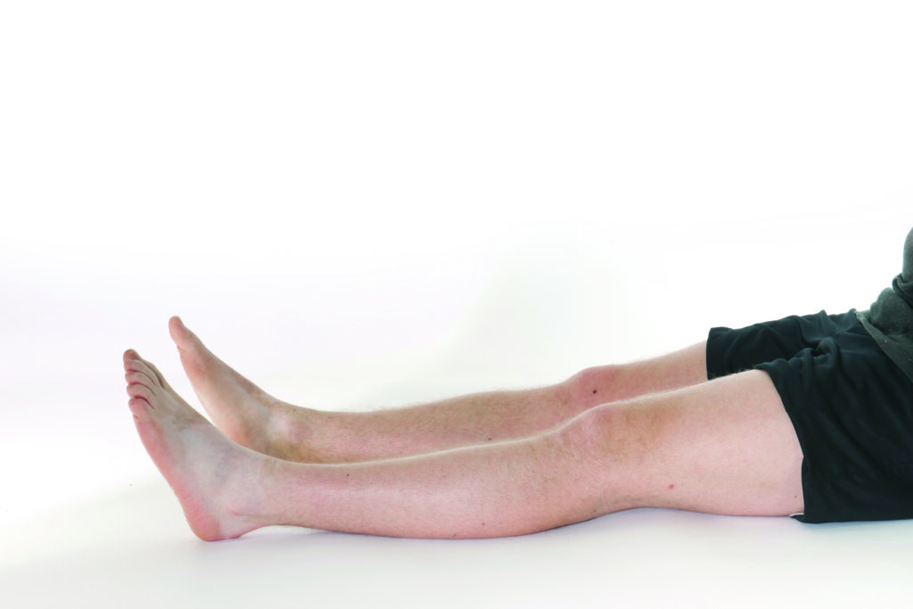 Photograph of a persons legs laying flat with feet relaxed