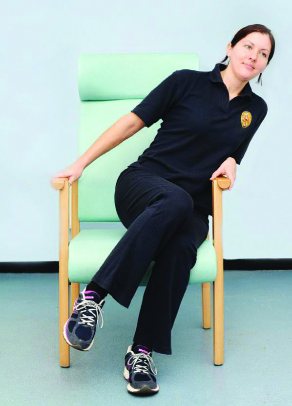 Photograph of a person moving side to side in a chair.