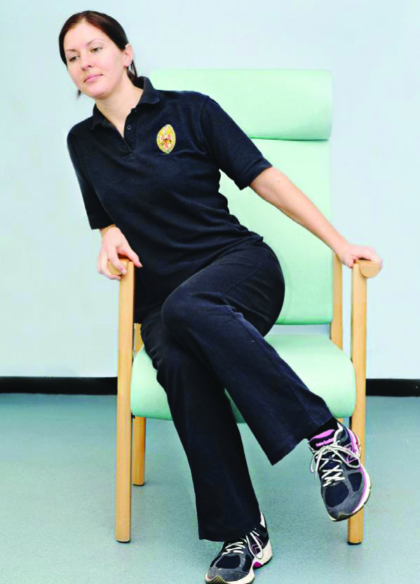 Photograph of a person moving side to side in a chair.