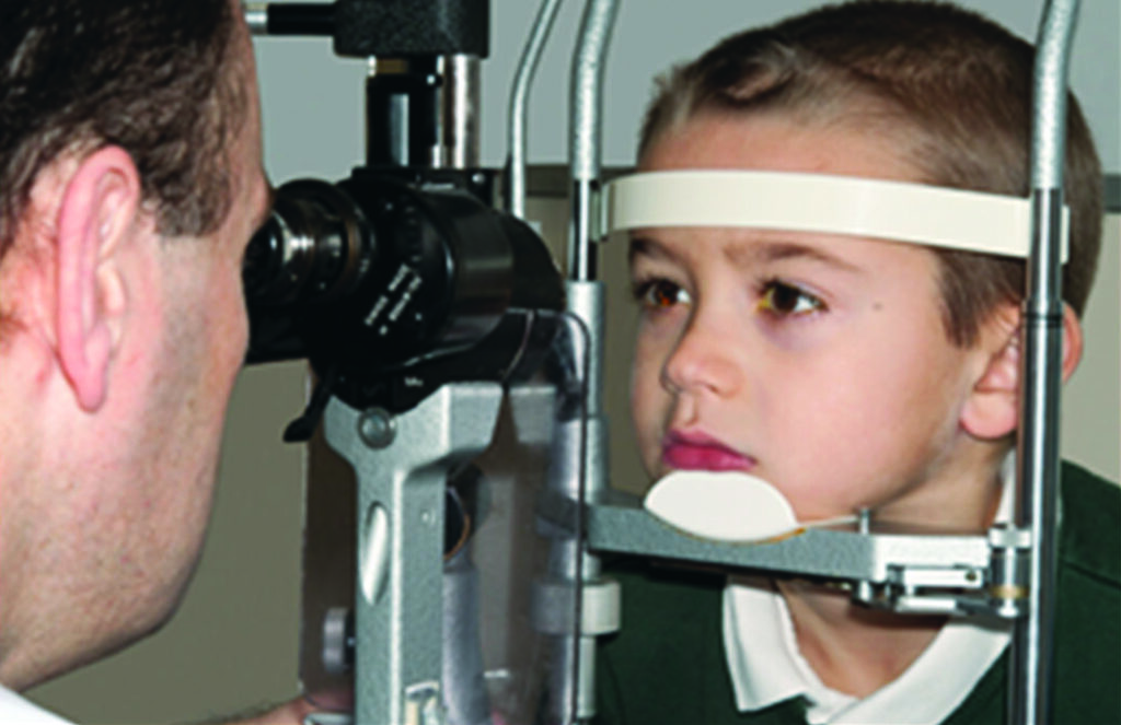 Photograph of a child using a slit lamp