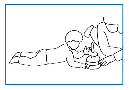 Image of child reaching for toys whilst on tummy