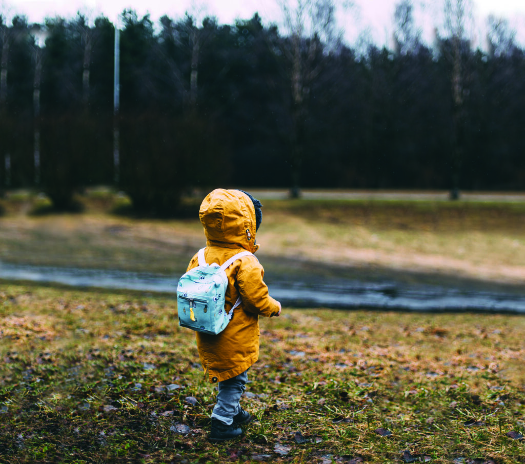 Image of child in raincoat outside