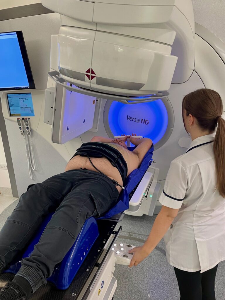 Photograph of a patient in treatment position on linear accelerator couch.