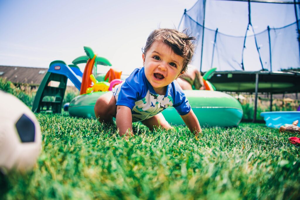 Image of child playing in a garden with toys