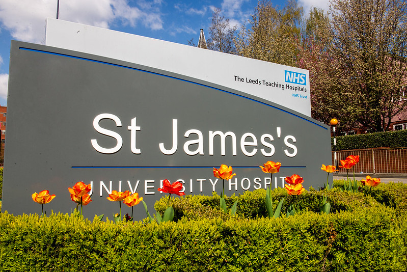 St James' University Hospital sign with flowers.