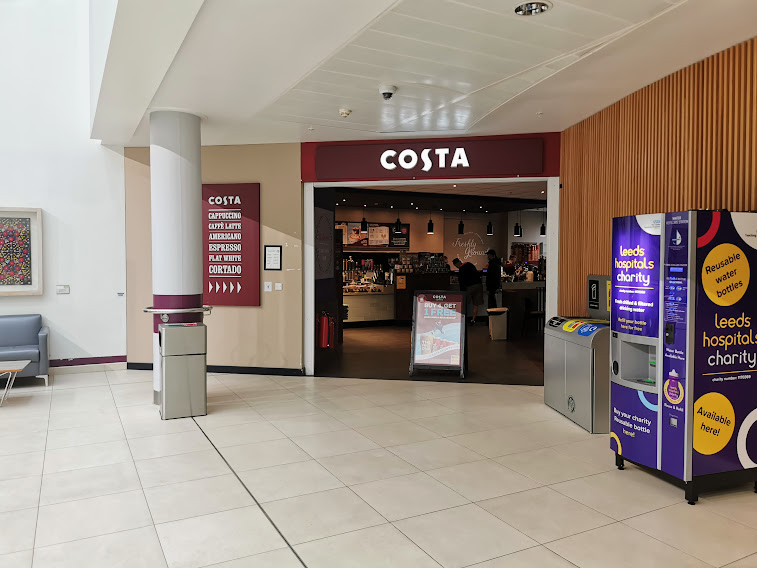 An image of the Costa cafes entrance on your right.