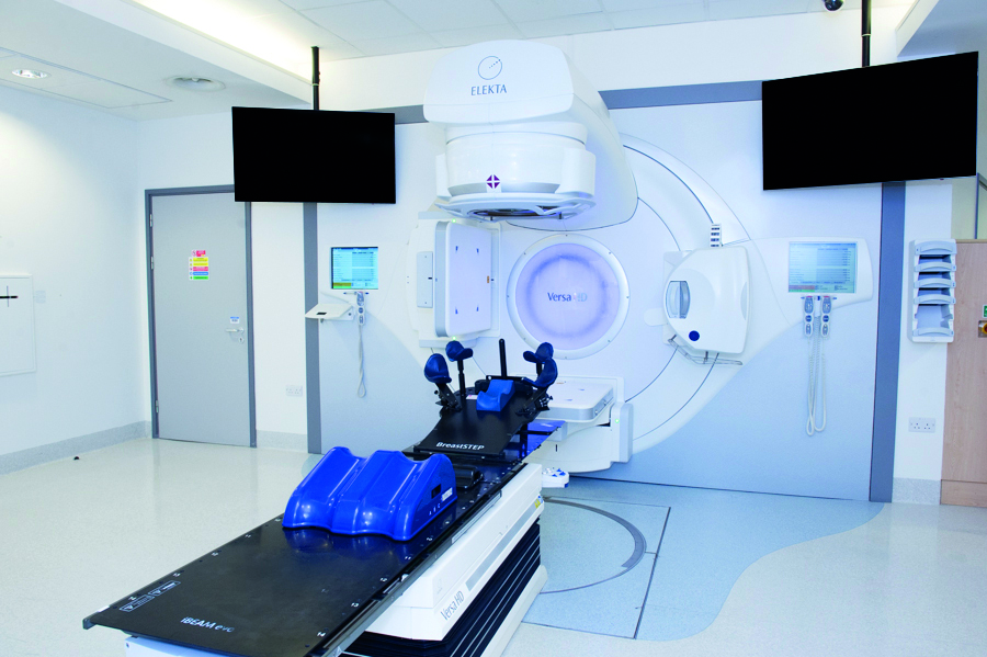 Photograph of a linear accelerator with breast equipment on couch.