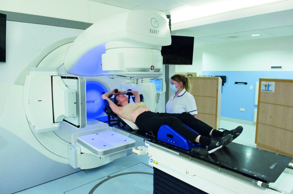 Photograph of a patient in treatment position on machine couch.