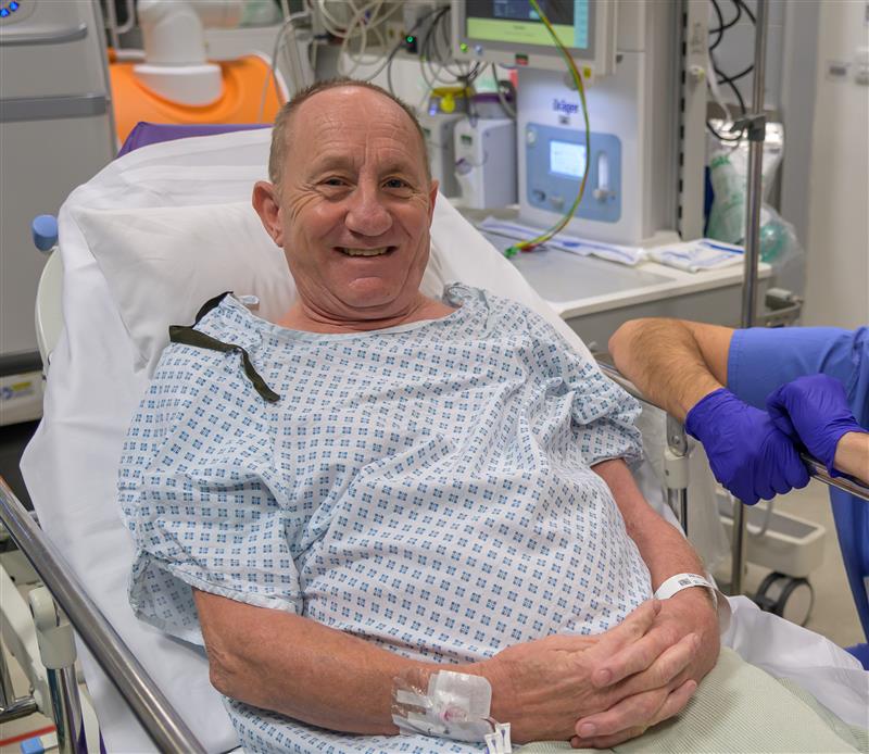 Patient in hospital bed smiling