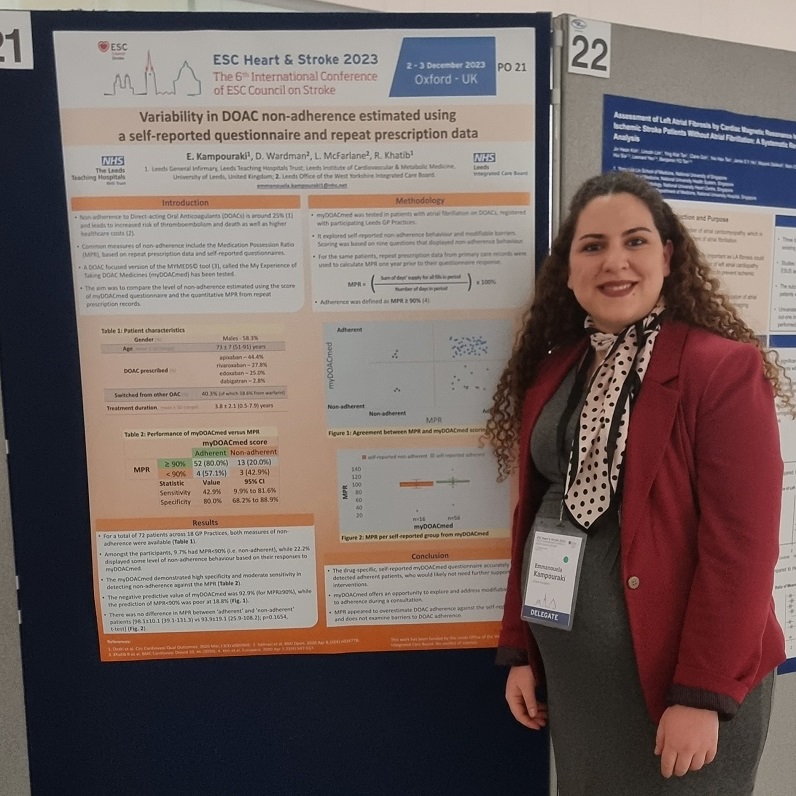 An image showing the InnoMeds Team member Dr Emma Kampouraki at the ESC Heart and Stroke Conference from December 2-3rd 2023 at Oxford. Standing beside a poster explaining Variability in Direct Oral Anticoagulants (DOAC) non-adherence estimated using a self-reported questionnaire and report prescription data.