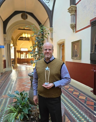 An image showing Dr Khatib holding the 2024 Primary Care Pharmacy Association Award.