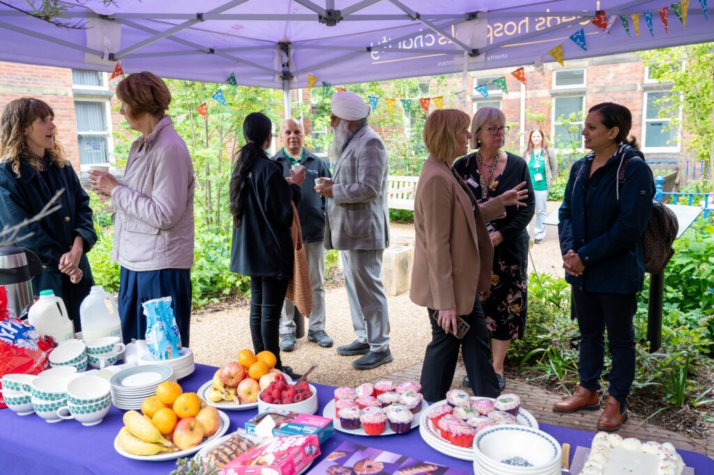  Group photo of guests enjoying refreshments at the Volunteers&rsquo; Week garden party.