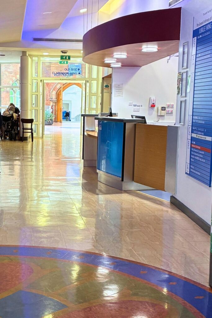 Reception desk and glass doors in the distance leading to old site and Clarendon Wing