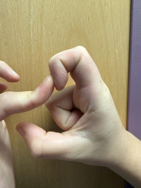 Image shows someone trying to bend the index finger as close to the palm as possible using the fingers on the other hand to stretch the tip of the index finger closer to the palm