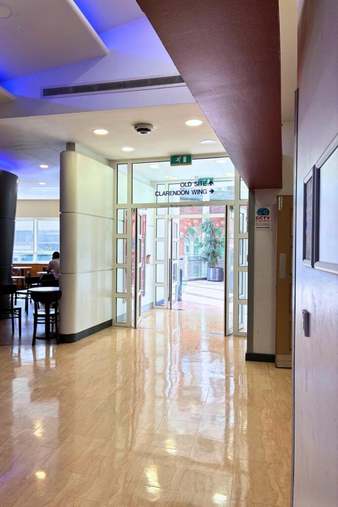 Glass doors leading to old site and Clarendon Wing