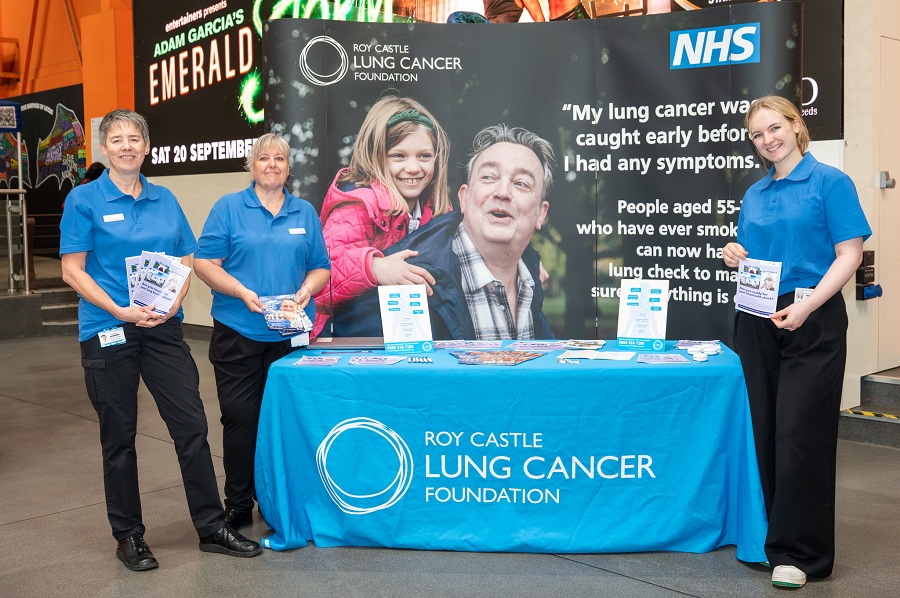 An image representing 3 team members of the Leeds Teaching Hospital NHS Trust Lung Cancer Screening Service teaming up with the Roy Castle Lung Cancer Foundation at an event. The team are showing off leaflets about their Service.