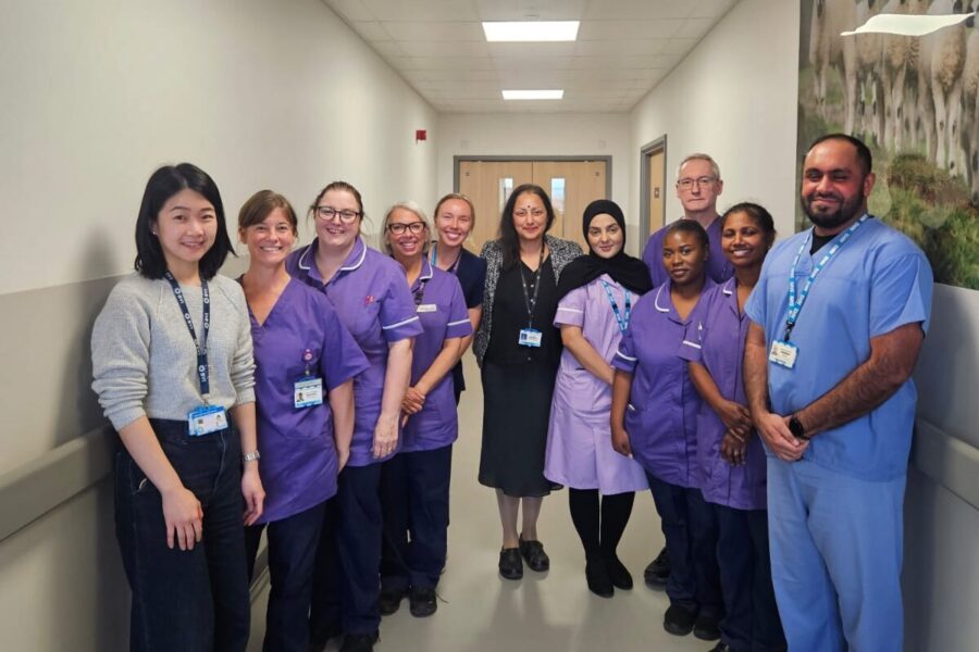 An image of the CLARITY research team standing in a line for a photo in a corridor.