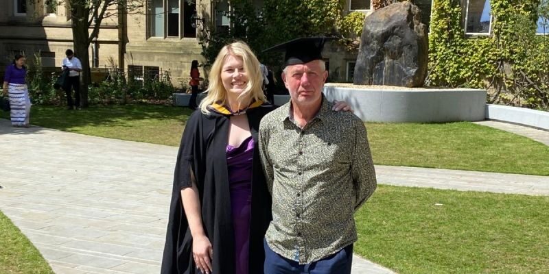 Rachel and Hugh Chown standing together at Rachel's MBA graduation in July 2024