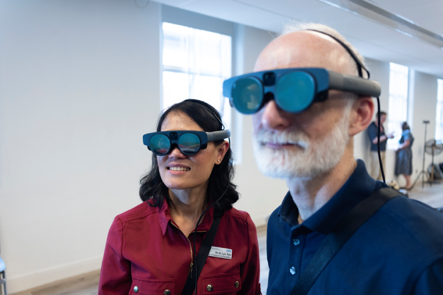 Dr Ai Lyn Tan and Professor Rory O'Connor demonstrate new augmented reality headsets
