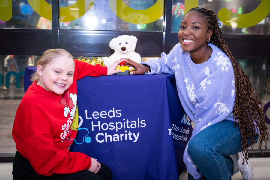 An image showing 2 females about to push a button to switch on the Christmas Lights at the Leeds Children's Hospital for 2023.