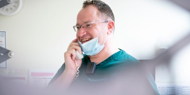Smiling clinical staff on phone